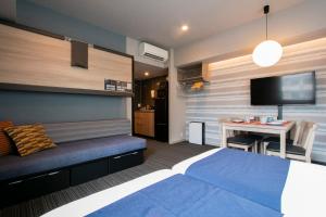 1 dormitorio con 1 cama y 1 mesa con TV en Minn Nishi-Kasai en Tokio