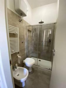 a bathroom with a shower and a toilet and a sink at Appartamento Note di Jesi in Iesi