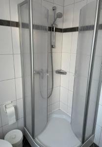 a shower stall in a bathroom with a toilet at Fewo Aurora im Haus Nautilus in Wangerooge