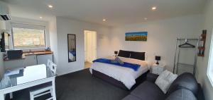 a bedroom with a bed and a couch at Boujee in Lake Tekapo