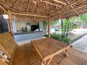 a wooden table and chairs on a patio at Baan Boon in Bangkok