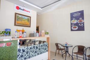 ein Esszimmer mit Tisch und Stühlen in der Unterkunft RedDoorz Plus @ Losari Makassar in Makassar