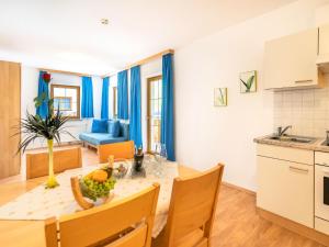 a kitchen and dining room with a table and chairs at Beautiful Apartment in Stubaital in a quiet location in Neustift im Stubaital