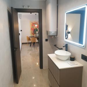 y baño con lavabo y espejo. en Urbanlux Olimpia Familiar en Albacete