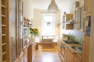 a kitchen with a sink and a table at Sunny Apartment near Belvédère Castle in Vienna