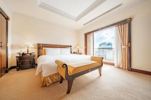 Postel nebo postele na pokoji v ubytování Lotte Hotel Saigon