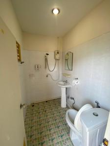 a bathroom with a toilet and a sink at Bangtao Corner in Bang Tao Beach