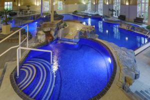 a large swimming pool with a water slide in a building at Slaley Hall Hotel, Spa & Golf Resort in Slaley