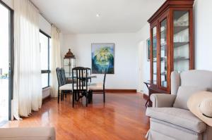 a living room with a table and chairs at Balcon del Mar MG by VillaGranCanaria in Arguineguín
