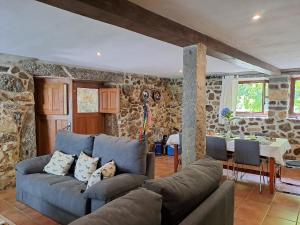 a living room with a blue couch and a table at Quinta da Tapada in Longos