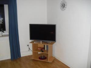 a flat screen tv sitting on a stand in a room at Haus Weiche in Flensburg