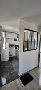 a kitchen with a white wall and a window at Résidence du soleil in Béziers +85 photos