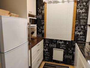 a kitchen with a refrigerator and a chalkboard wall at Rukan Mestari in Ruka