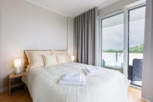 Posteľ alebo postele v izbe v ubytovaní Apartament Plaża