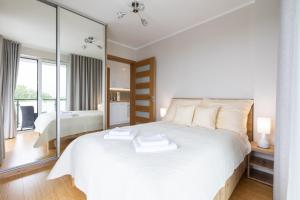 Posteľ alebo postele v izbe v ubytovaní Apartament Plaża