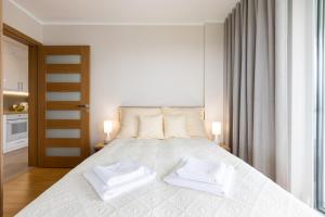 Posteľ alebo postele v izbe v ubytovaní Apartament Plaża