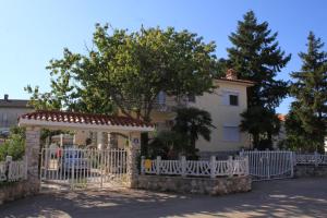 a white fence in front of a house at Apartments with a swimming pool Valbandon, Fazana - 7257 in Marana