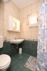 a bathroom with a toilet and a sink at Apartments with a swimming pool Valbandon, Fazana - 7257 in Marana