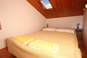 um quarto com uma cama com lençóis amarelos e uma janela em Apartments with a parking space Pula - 7203 em Pula
