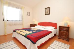 a bedroom with a large bed and a window at Apartments with a parking space Liznjan, Medulin - 7224 in Ližnjan