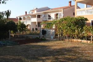 a large white house with trees in front of it at Apartment Peroj 7254b in Vodnjan