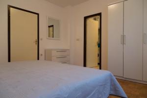 a bedroom with a bed and two closets at Apartment Peroj 7254b in Vodnjan