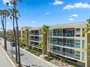 an image of an apartment building with palm trees at Beautiful Beachside Apartment With Marina View in Los Angeles