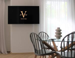Televízia a/alebo spoločenská miestnosť v ubytovaní Ventiri Family Suite 1
