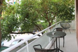 a patio with a table and chairs on a balcony at Ventiri Family Suite 1 in Athens