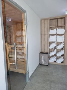 a room with a closet filled with white towels at Grimm's Potsdamer Platz in Berlin