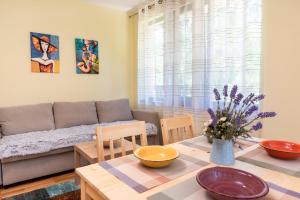 a living room with a couch and a table at Bendida Park in Velingrad