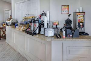 a kitchen counter with many items on it at Days Inn & Suites by Wyndham Huntsville in Huntsville