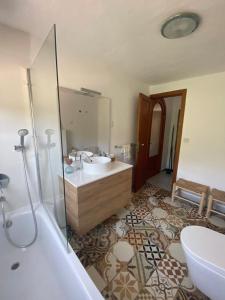 a bathroom with a tub and a sink and a bath tub at Ses Alzines Apartamento integrado en Casa Rural Habitada in Llucmajor