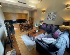 a living room with a couch and a table at Quebecs Luxury Apartments in Leeds