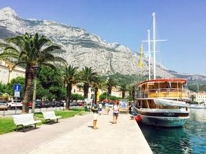 a boat is docked at a dock with a mountain at Traditional gulet, cruises & events in Split
