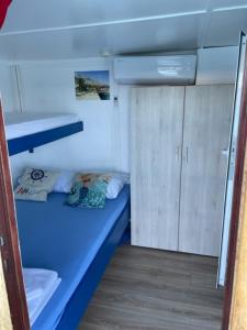 a small room with a blue bed in a boat at Traditional gulet, cruises & events in Split