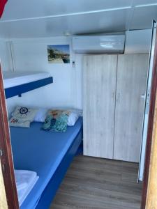 a small room with a blue bed in a boat at Traditional gulet, cruises & events in Split