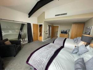 a bedroom with a large bed and a living room at Quebecs Luxury Aparthotel in Leeds +37 photos