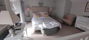 a bedroom with a bed with two towels on it at Samphire Cottage in Helston