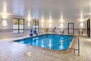 a pool in a hotel room with a swimming pool at Quality Inn Central in Albany