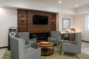 a living room with chairs and a fireplace at Best Western Colfax in Colfax