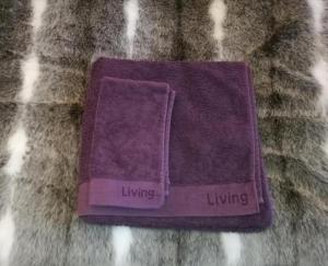 a purple napkin with the words living on it at RovaVisit Apartments Siljo in Rovaniemi