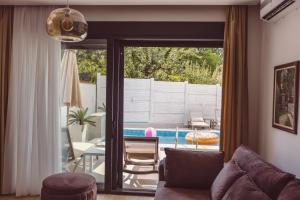 a living room with a couch and a view of a pool at Mi Casa 2 in Vrdnik