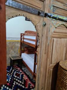 um quarto com um beliche e um espelho em Museum House - Dar Melyani em Fez