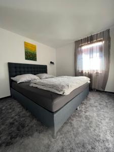 a bedroom with a bed in a room with a window at 659 apartments in Vinné