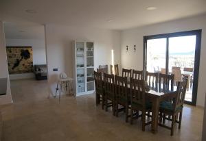 a dining room with a wooden table and chairs at Casa Rural la Montana 2 in Chella