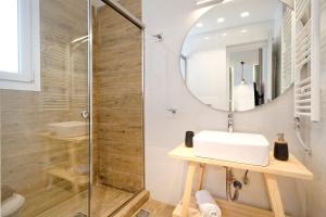 a bathroom with a sink and a shower at Eos Residence in Athens