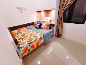 a small bedroom with a bed with a colorful comforter at Legoland- HapySunshine@DPristine-2B2R-8px Lakeview in Nusajaya