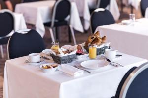 a table with a tray of food and drinks on it at Westotel Tours Val de Loire in La Ville-aux-Dames