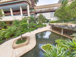 a pool in the middle of a courtyard in a building at Afiniti, 2 min walk to legoland and Gleneagles Hospital By Hint Homestay in Nusajaya